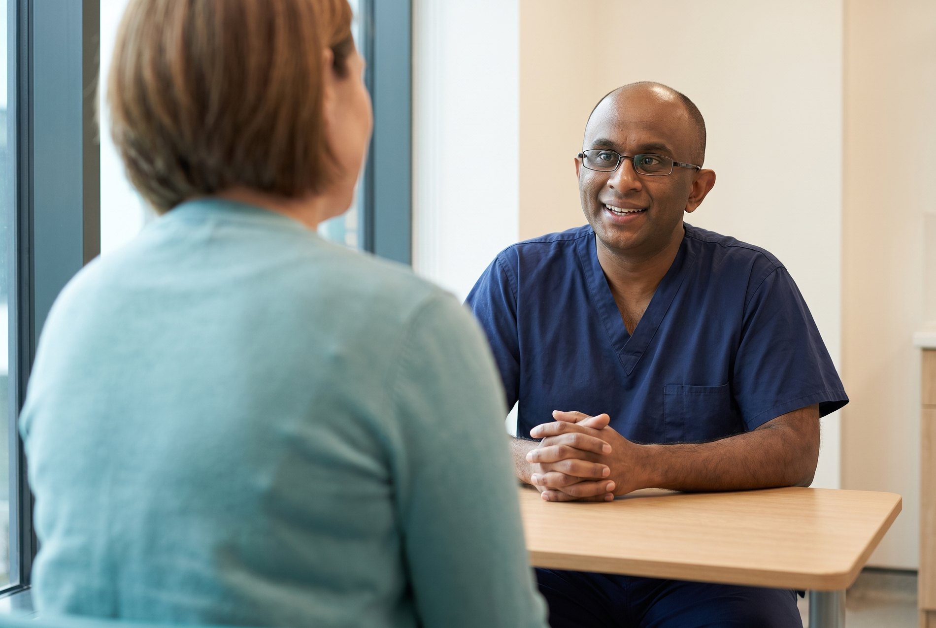 Dr Ashok Gunawardene in consultation with a patient